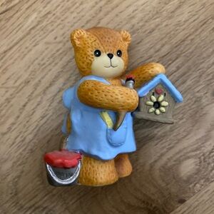 Lucy & Me painting a bird house bear figurine